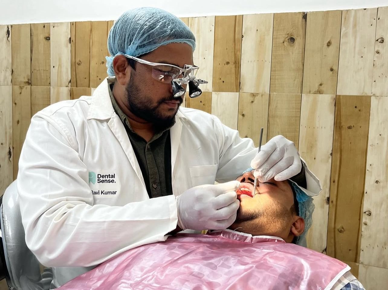 Dr. Ravi Kumar performing painless dental treatment at Dental Sense in Patna